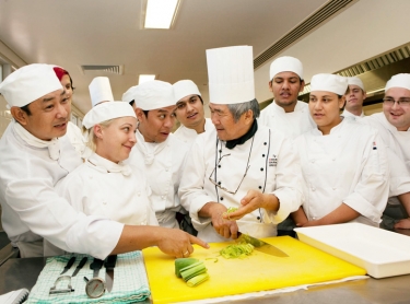 Teachers and students at CDU learning cooking skills. Employment and training, education