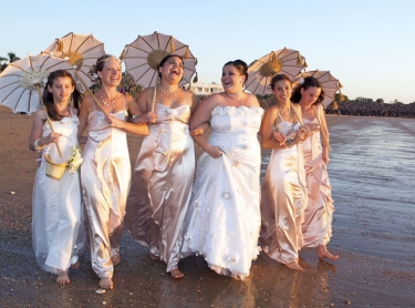 Bride and bridesmaids on the beach
