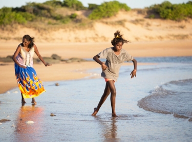 Yolngu women - grandmother Doris Yethun Dahmbing Burarrwanga, daughter Abby Dhamarrandji (23) and grand daughters Grace Bururrwanga (12) and Rekisha Gaykamaangu (3) walk along the beach at NGayawili, on Elcho Island