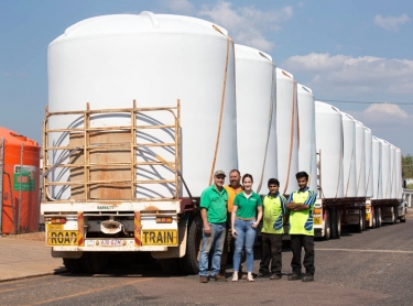 Plastic water tanks manufactured by Terracorp in Darwin are loaded for transport to pastoral station.