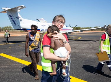 The Royal Flying Doctor Service (RFDS) in Broome. Operations base, aircraft and staff working with patients in Broome and a medical clinic at Yakanarra near the Fitzroy River. Dr Nola McPherson carries ten month-old Marlon Macarthur off a RFDS Pilatus PC-12 aircraft after the baby boy was evacuated from a remote Kimberley community, to Broome. Accompanied by nurse Rachel Climpson and the boy's grandfather, Douglas Macarthur.